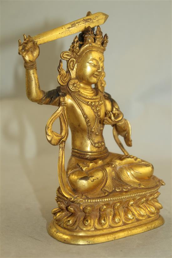 A Tibetan gilt bronze figure of Manjushri, 18cm